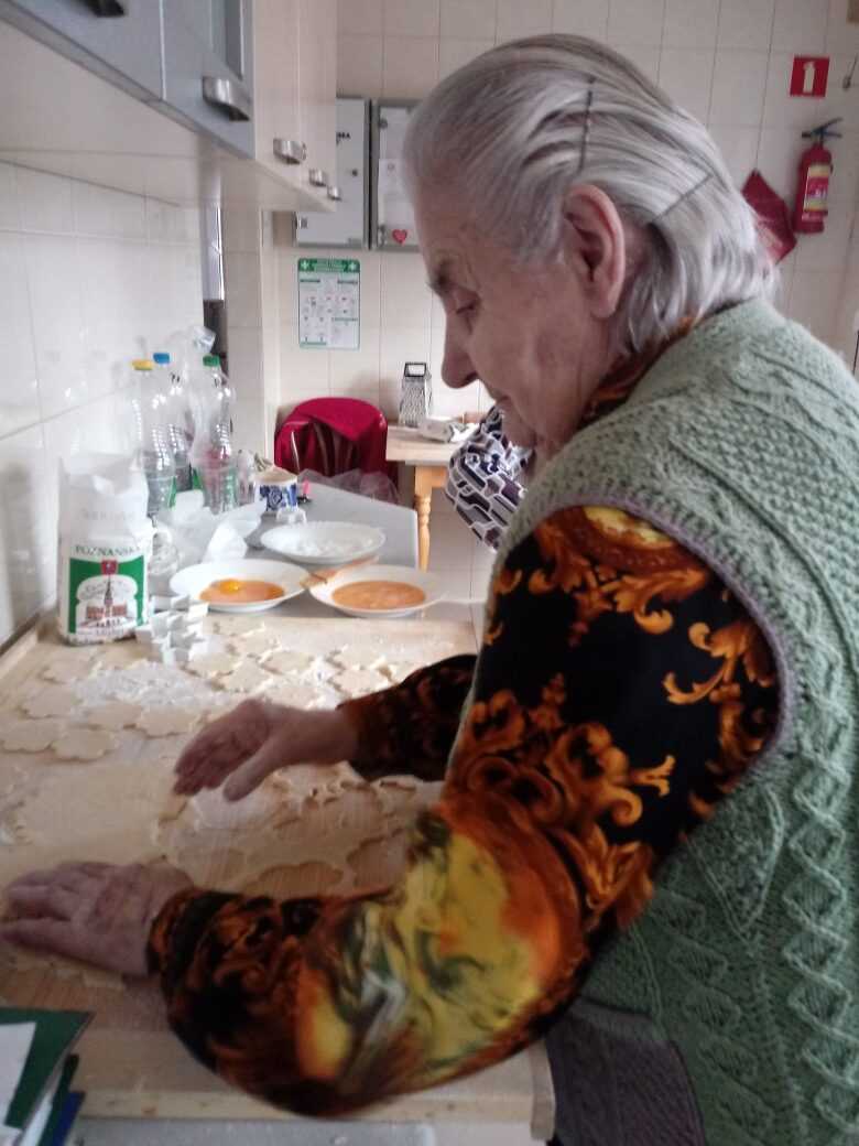 mieszkanka DPS pomaga w pieczeniu ciastek